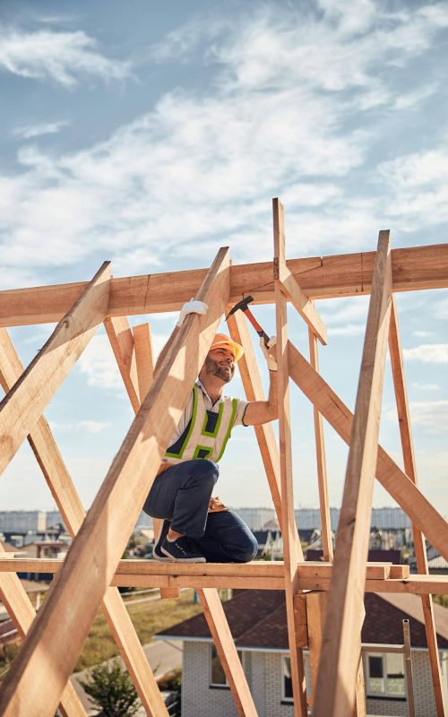 Builder in charge of a hammer-work at a construction site