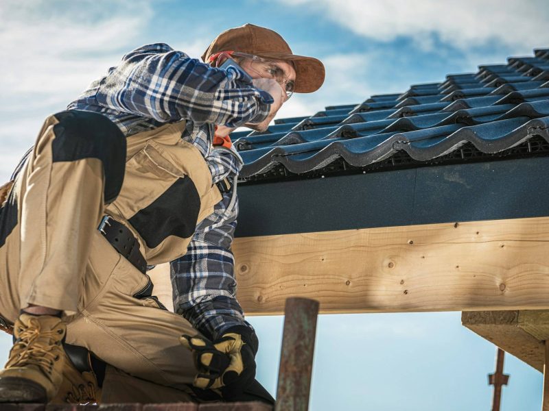 Roof Contractor Talking On Cell Phone.